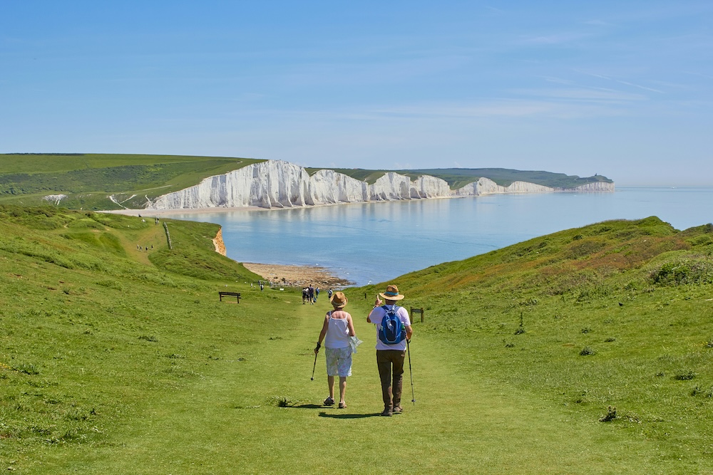 Active seniors hiking coastal cliffs in retirement